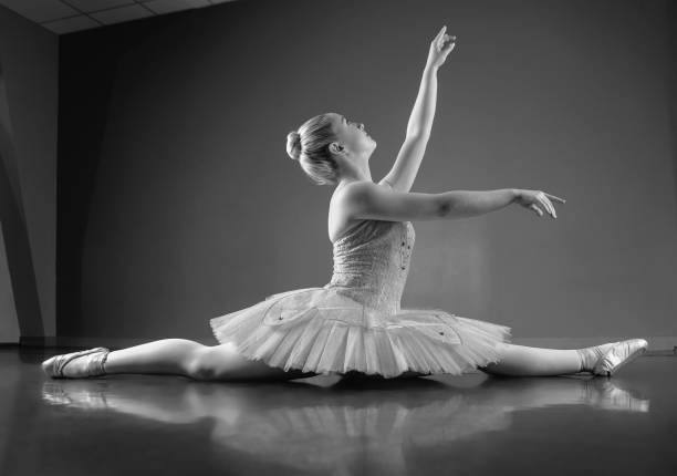 istock Graceful ballerina sitting with legs stretched out 816915404