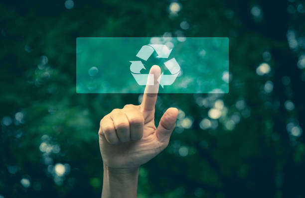 Hand pressing button ecology interface with arrow recycling. Hand pressing recycling symbol on button touch screen. Environmental concept recycle. stock photo