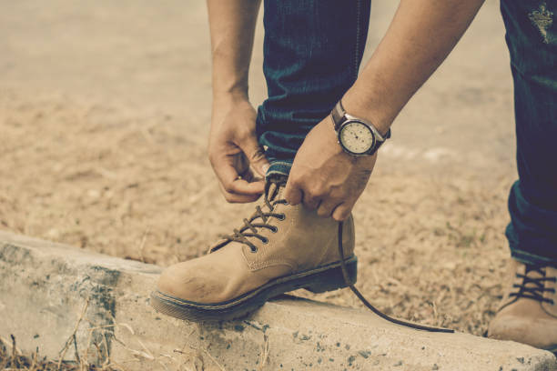 istock Man tighten or laces the shoe vintage tone filter. 816941248