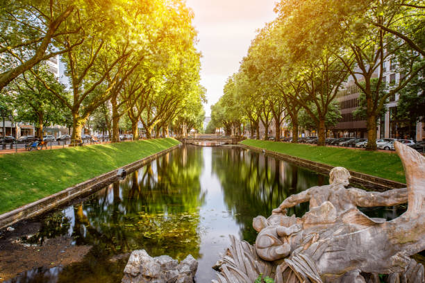 Water canal in Dusseldorf city View on the Konigsallee boulevard with water canal in Dusseldorf, Germany. Long exposure image technic north rhine westphalia photos stock pictures, royalty-free photos & images