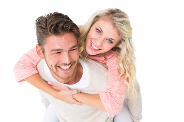 istock Handsome man giving piggy back to his girlfriend 816968656