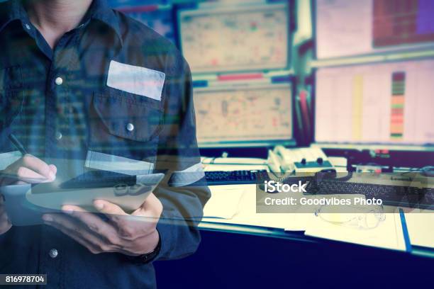 Double Exposure Of Engineer Or Technician Man In Working Shirt Working With Tablet In Control Room Of Oil And Gas Platform Or Plant Industrial For Monitor Process Business And Industry Concept Stock Photo - Download Image Now