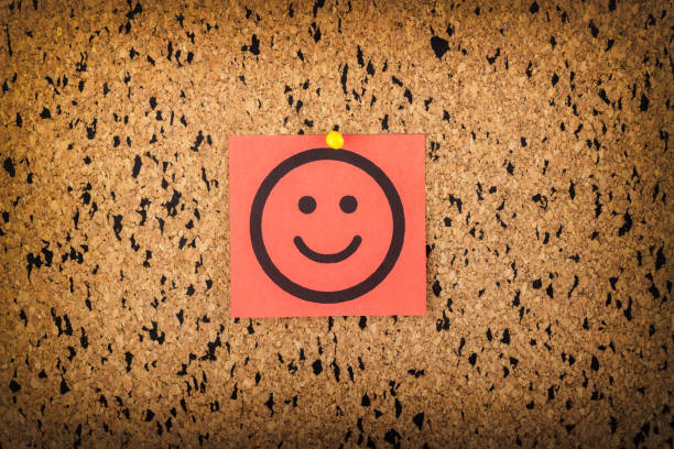 istock red paper with smiling face on corkboard. bulletin board. 816997234