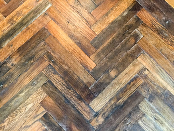 istock Close-up of herringbone pattern rustic hardwood floor 817008320