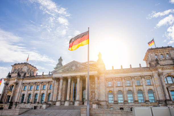 Berlin city view View on the famous Reichtag parliament building with flag during the morning light in Berlin city bundestag photos stock pictures, royalty-free photos & images