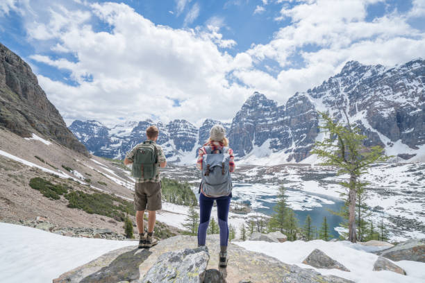 istock Couple of hikers overlooking mountain lake 817024042