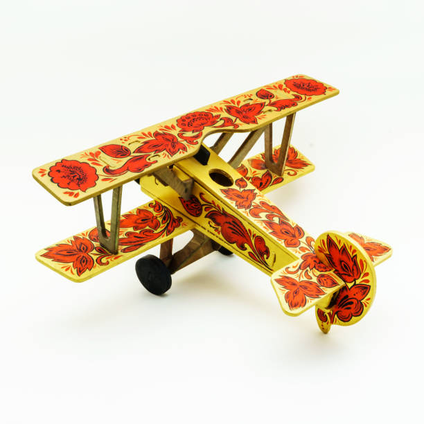 istock Toy airplane painted in khokhloma style on white background 817026274