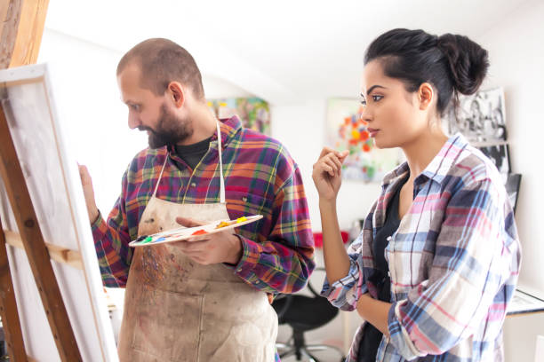 istock Couple fine artists drawing in studio 817026526