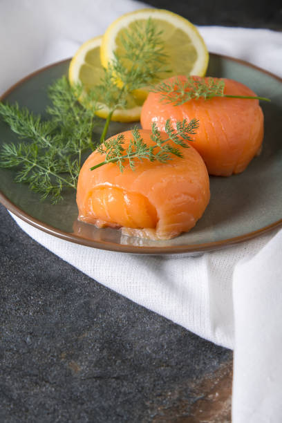 istock Smoked salmon, mousse, pate with dill and lemon. Dark background 817036908