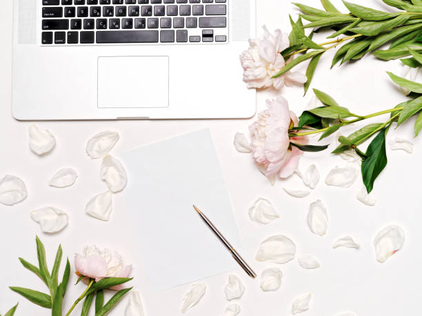 istock Workplace with laptop pen peonies 817037126
