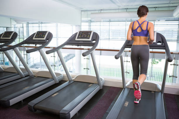 istock Fit brunette running on the treadmill 817039990