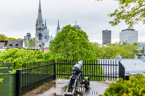 Quebec City: Cityscape of old town with church steeples and cannon at Parc du Cavalier du Moulin