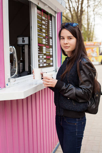 istock Lunch time. Young woman buying coffee 817058948