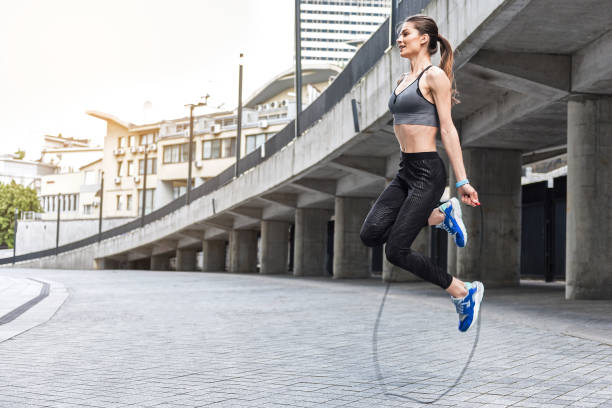 istock Joyful girl skipping on rope near stadium 817064176