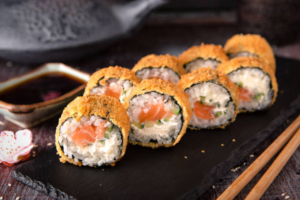 istock Hot fried Sushi Roll with salmon, avocado and cheese. Sushi menu. 817071822