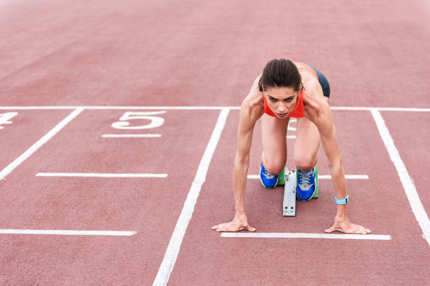 istock Confident girl posing in blocks to start running 817071960