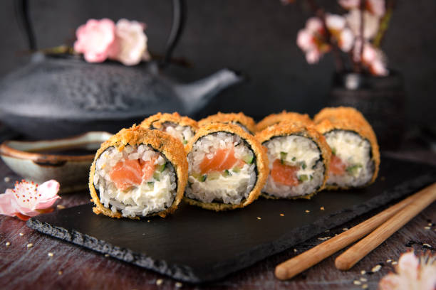 istock Hot fried Sushi Roll with salmon, avocado and cheese. Sushi menu. 817073858