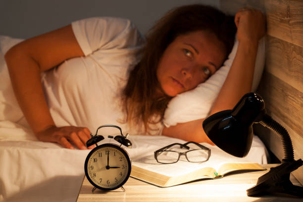 istock Woman lying in bed suffering from insomnia 817074032
