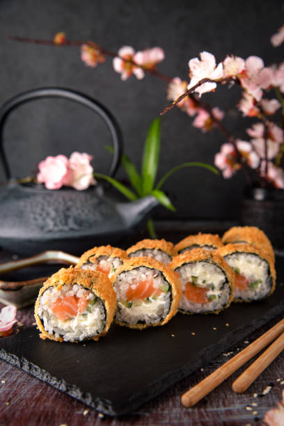 istock Hot fried Sushi Roll with salmon, avocado and cheese. Sushi menu. 817076178