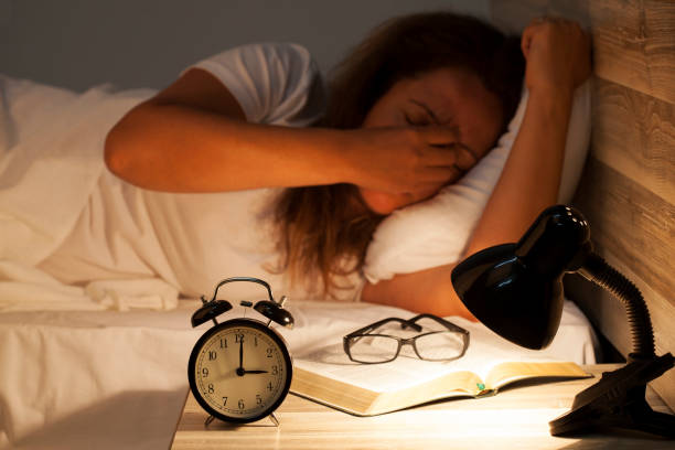 istock Woman lying in bed suffering from insomnia 817076196