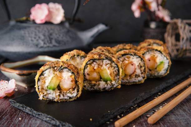 istock Hot fried Sushi Roll with shrimp, cucumber and unagi sauce. Sushi menu. 817076590