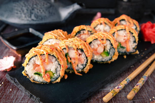 istock Hot fried Sushi Roll with salmon, shrimp, onion, avocado and cheese. Sushi menu. 817084028