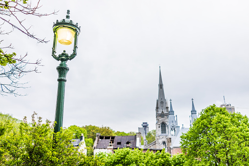 Quebec City: Cityscape of old town with church steeples and illuminated lantern or lamp at Parc du Cavalier du Moulin