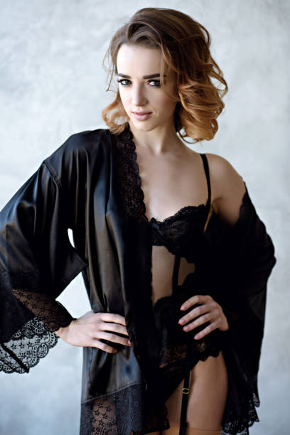 istock Beautiful sexy lady in elegant black robe 817089794