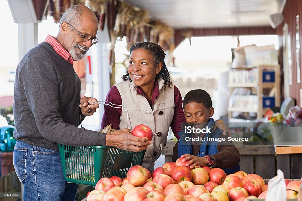 Grandparents and their grandson choosing apples  Autumn Stock Photo