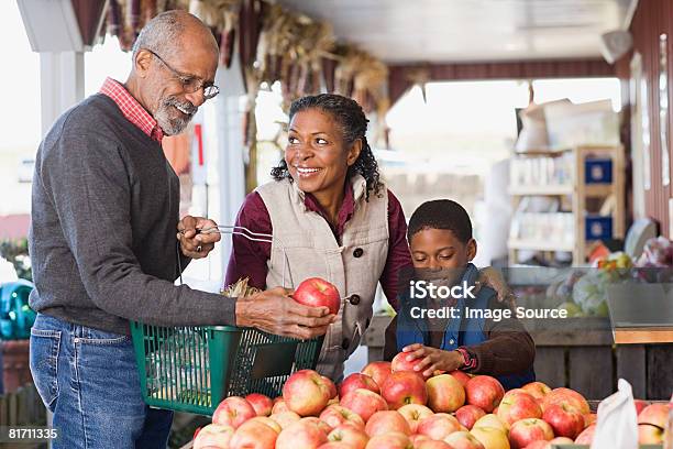 Grandparents And Their Grandson Choosing Apples Stock Photo - Download Image Now - Autumn, Apple - Fruit, Senior Adult