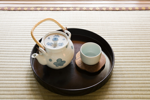 Delicious tea with milk in white cup on wooden table