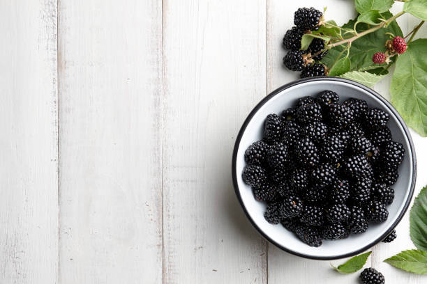 istock Bowl of fresh blackberries on stone background 817121716