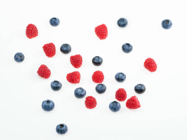istock Raspberries and blueberries on white background.  top view 817123818