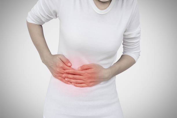 istock Woman stomachache on gray wall background. 817123976
