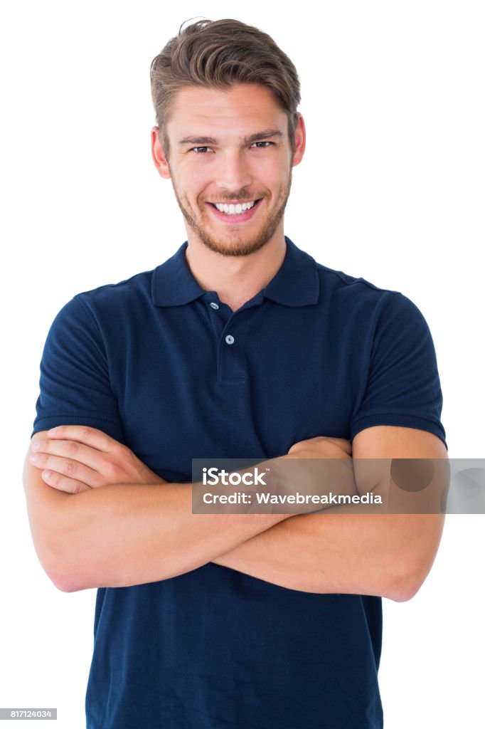 Handsome young man smiling with arms crossed Handsome young man smiling with arms crossed on white background Men Stock Photo