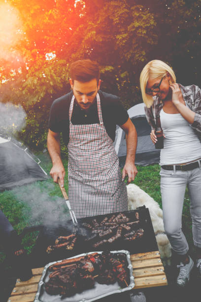 istock Young couple in nature preparing food 817131506