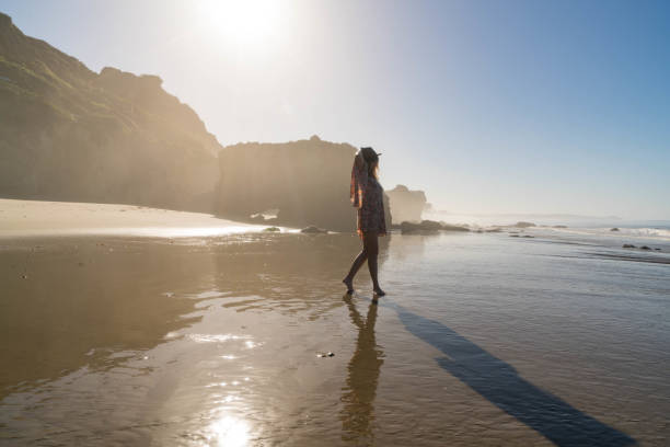 istock Woman on Reflective Beach Sand 817138554