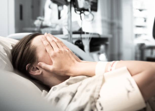 Stressed young woman patient at the hospital Young woman patient lying at hospital bed feeling sad and depressed worried. Disease feeling sick in health care and clinical attention concept sick woman hospital bed stock pictures, royalty-free photos & images