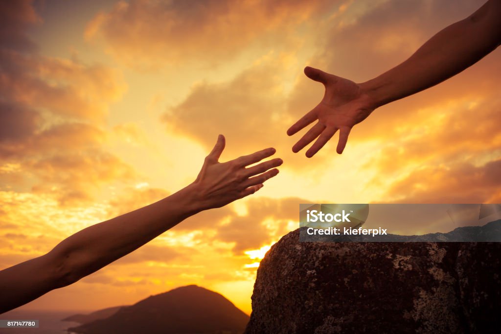 Helping hands Giving a helping hand. Reaching Stock Photo