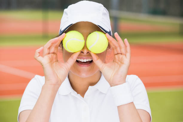 istock Pretty tennis player holding balls over her eyes 817156900