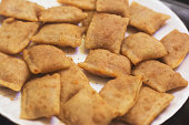 Pizza rolls on a white background at an angled view.