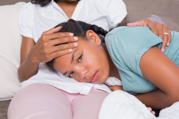 istock Sick daughter lying on mothers lap 817174558
