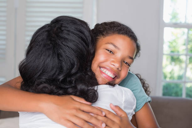 istock Mother and daughter hugging on the couch 817174684