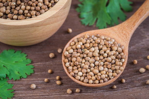 istock Coriander seeds on wooden spoon 817177380