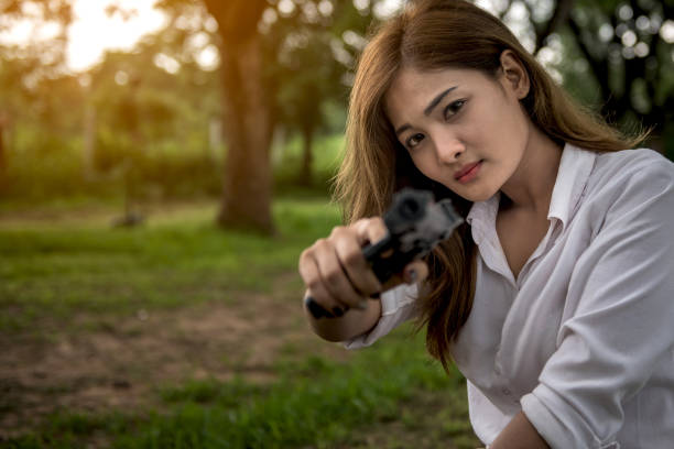 istock Gun in hand beautiful woman 817177390