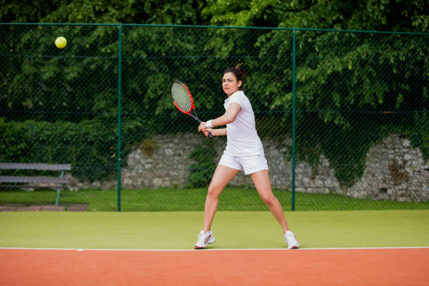 istock Pretty tennis player about to hit ball 817180286