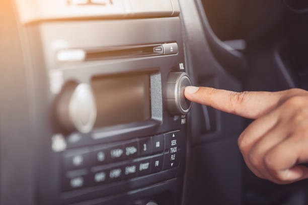 istock Woman hand turn on the radio  while driving a car 817180318