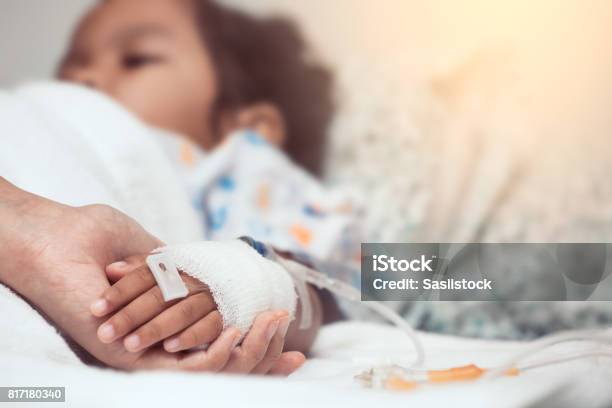 Mother Hand Holding Child Hand Who Have Iv Solution In The Hospital With Love And Care Stock Photo - Download Image Now