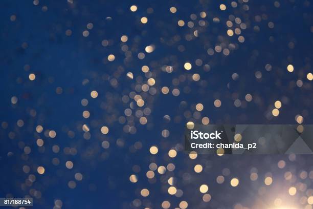 Glittering Blur Circular Gold On Blue Background And Bright Stock Photo - Download Image Now