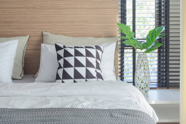 istock Black and white bedding style and crystal jar next to bed 817191066